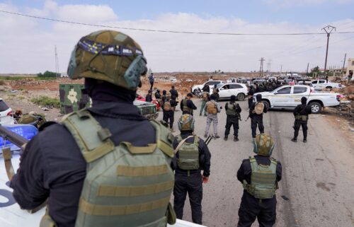 Members of Syria's Internal Security Forces stand guard at a checkpoint working to prevent Bedouin fighters from advancing towards Suwayda
