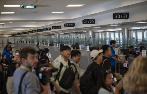 Travelers at Dulles International Airport in Virginia are pictured during a media event related to incoming foreign nationals on June 29. The United States will require international visitors to pay a new “visa integrity fee” of at least $250.