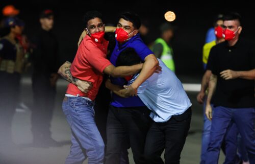 Detained Venezuelans embrace upon arrival at Simon Bolivar International Airport as part of a detainee exchange agreement between Venezuela and the United States on July 18 in Caracas