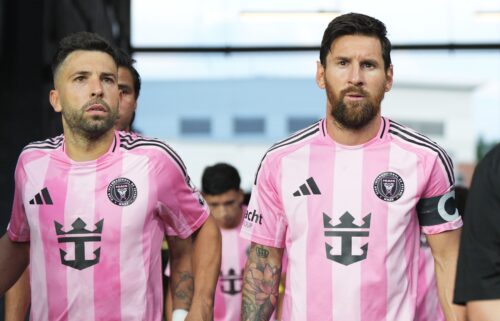 Inter Miami star Lionel Messi (right) and teammate Jordi Alba (left) enter the pitch during an MLS match against FC Cincinnati on July 16.  MLS announced on July 25 that Messi and Alba will be suspended for the team’s next game against FC Cincinnati on Saturday.