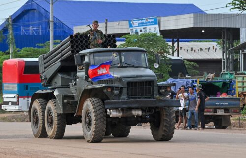 A Cambodian soldier stands on a truck carrying a Russian-made BM-21 rocket launcher travelling along a street in Oddar Meanchey province on July 25.
