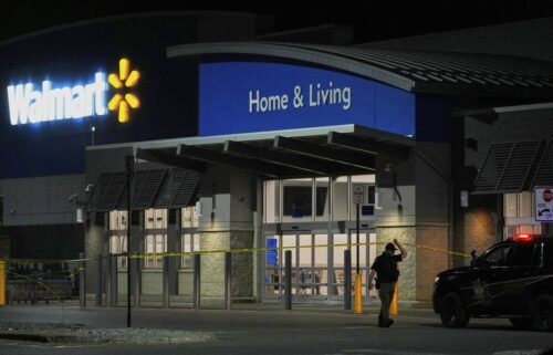 Police officers speak to Walmart employees outside a Walmart store