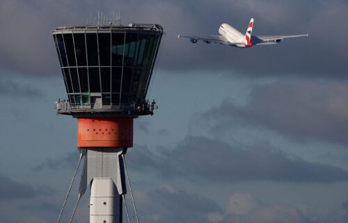 A British Airways Airbus A380 takes off in view of the control tower at Heathrow Airport