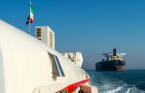 This 2018 photo shows a support vessel maneuvering a the crude oil tanker as it sails through the Persian Gulf to transport crude oil to export markets in Bandar Abbas