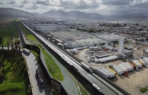 An aerial image shows trucks coming from Mexico enter the US to an inspection station after crossing the border in Otay Mesa