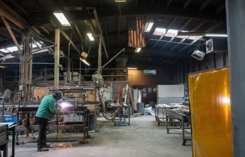A worker arc welds a metal door during production at the Metal Manufacturing Co. facility in Sacramento