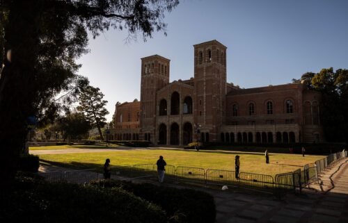 Security officers stand guard on the lawn in front of UCLA's Royce Hall in May 2024. UCLA is the latest major institution of higher learning to see promised research funding snatched away by the Trump administration.