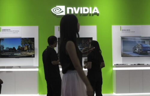 People visit the booth of Nvidia at an supply chain expo in Beijing