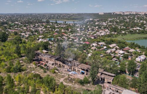 Rescuers from the Emergency Services of Ukraine extinguish a blaze in the aftermath of a Russian drone strike on a warehouse storing food products in Sloviansk