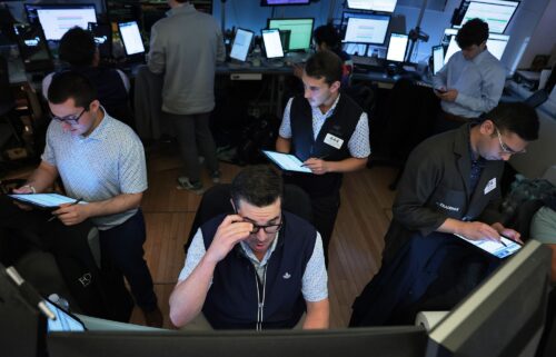 Traders work on the floor of the New York Stock Exchange during afternoon trading on August 1