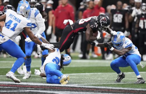 Detroit Lions safety Morice Norris  is hit in the helmet by Atlanta Falcons running back Nathan Carter (38) during the second half of an NFL preseason football game Friday.