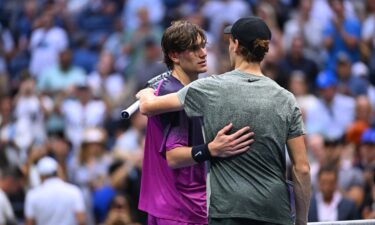 Jannik Sinner and Draper (in purple) at the end of their semifinal at the 2024 US Open.
