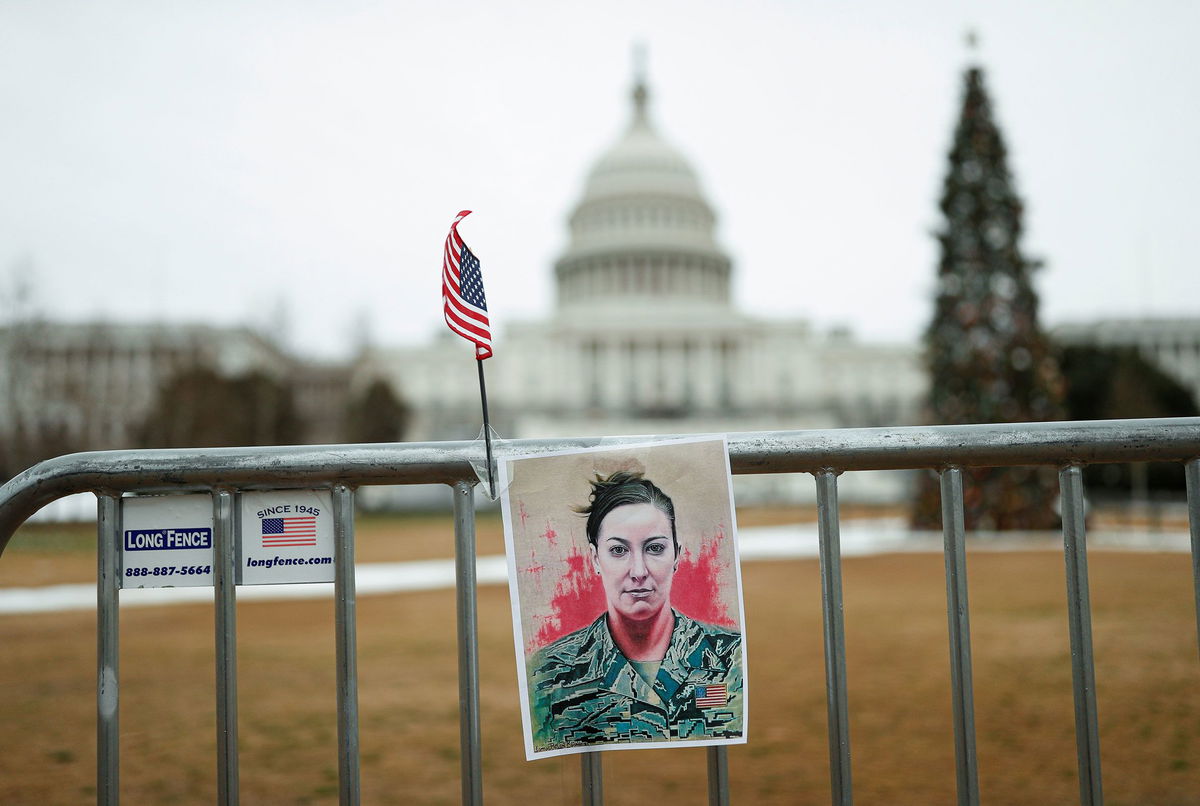 <i>Tom Brenner/Reuters/File via CNN Newsource</i><br/>A poster of Ashli Babbitt