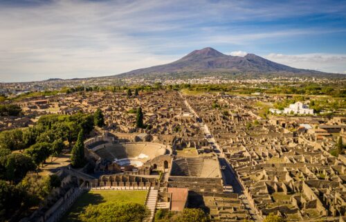 An aerial view of Pompeii is pictured with Mount Vesuvius in the background.