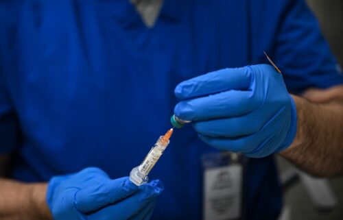 A health worker prepares a dose of the measles vaccine at a health center in Lubbock
