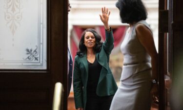 State Rep. Nicole Collier waves to supporters from inside the House Chamber at the Texas Capitol.