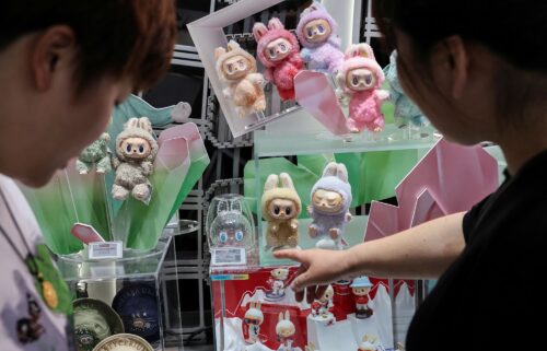 Labubu (R) and CryBaby (L) attached to a shopper's handbag outside the Pop Mart store in Siam Square in Bangkok.