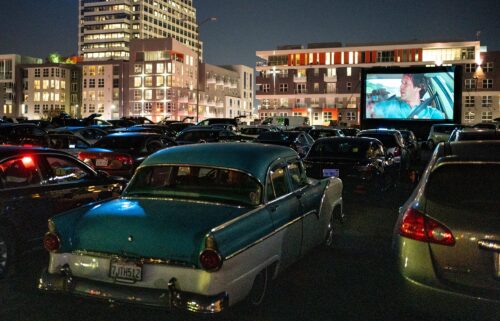 Moviegoers watch "National Lampoon's Vacation" at the Electric Dusk Drive-In on August 8