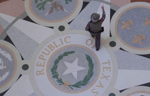 A Texas troopers passes the Texas Seal in the Rotunda of the Texas Capitol before debate on a bill on a redrawn U.S. congressional map during a special session in the Senate Chamber in Austin