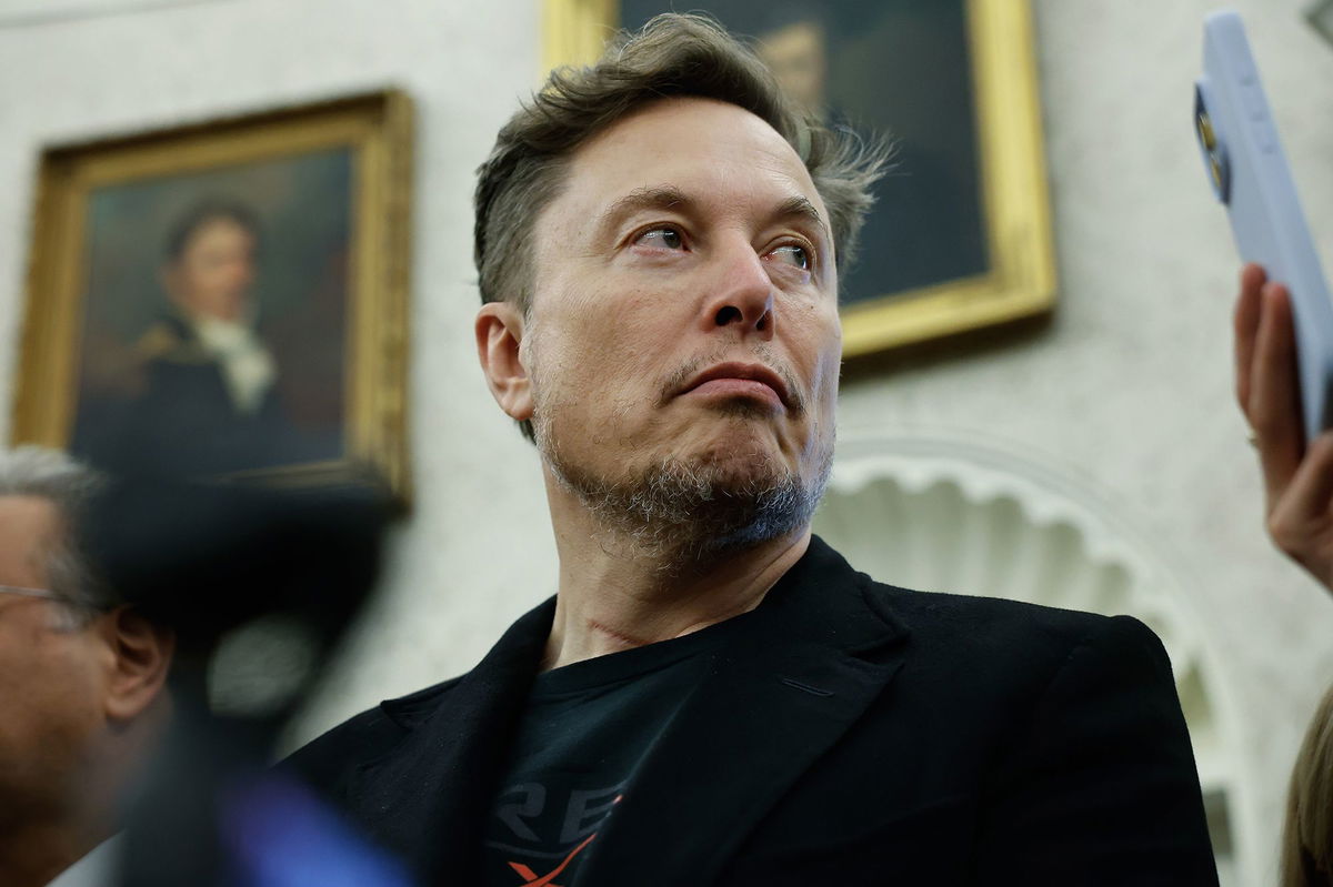 <i>Chip Somodevilla/Getty Images via CNN Newsource</i><br/>Elon Musk listens as reporters ask U.S. President Donald Trump and South Africa President Cyril Ramaphosa questions in the Oval Office.