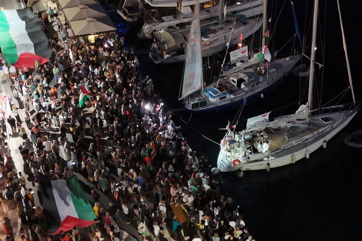 <i>Giorgos Solaris/Reuters via CNN Newsource</i><br/>A screenshot from a drone video shows people gathering at a Greek port before the departure of two boats taking part in the Global Sumud Flotilla on September 14.