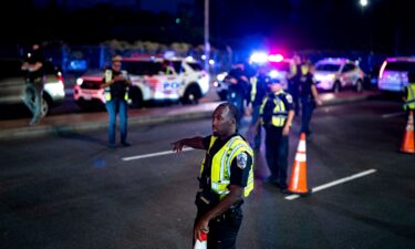A Metropolitan Police Department officer directs a vehicle to a secondary inspection at a checkpoint in the Ivy City neighborhood of Washington