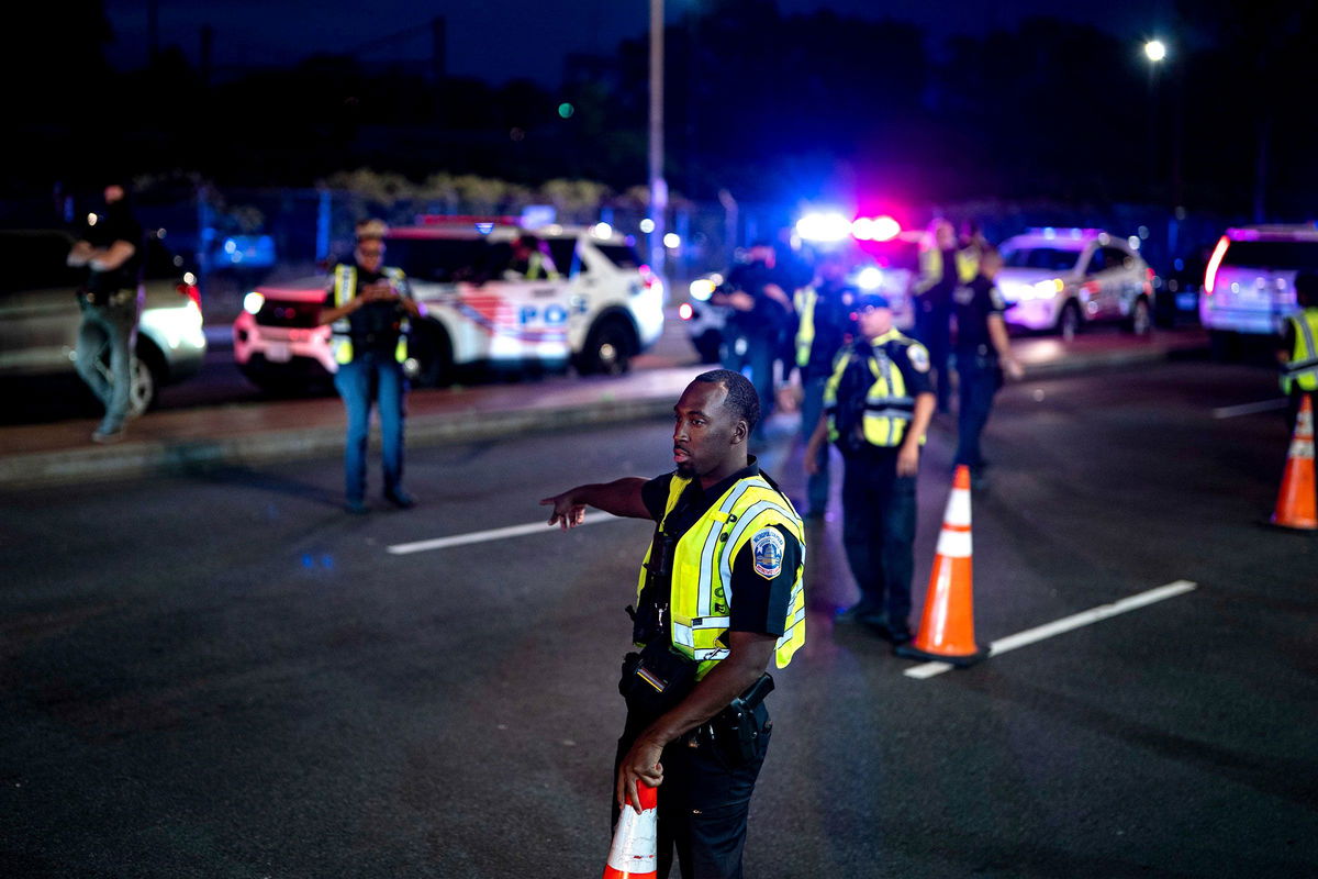 <i>Al Drago/Bloomberg/Getty Images via CNN Newsource</i><br/>A Metropolitan Police Department officer directs a vehicle to a secondary inspection at a checkpoint in the Ivy City neighborhood of Washington
