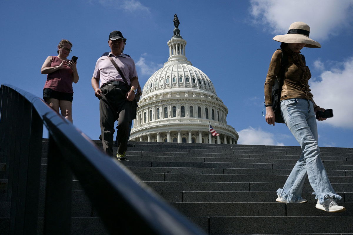<i>Oliver Contreras/AFP/Getty Images via CNN Newsource</i><br/>Visitors walk down the stairs outside the US Capitol in Washington