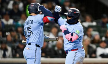 Vladimir Guerrero Jr. (right) and Anthony Santander celebrate against the Mariners.