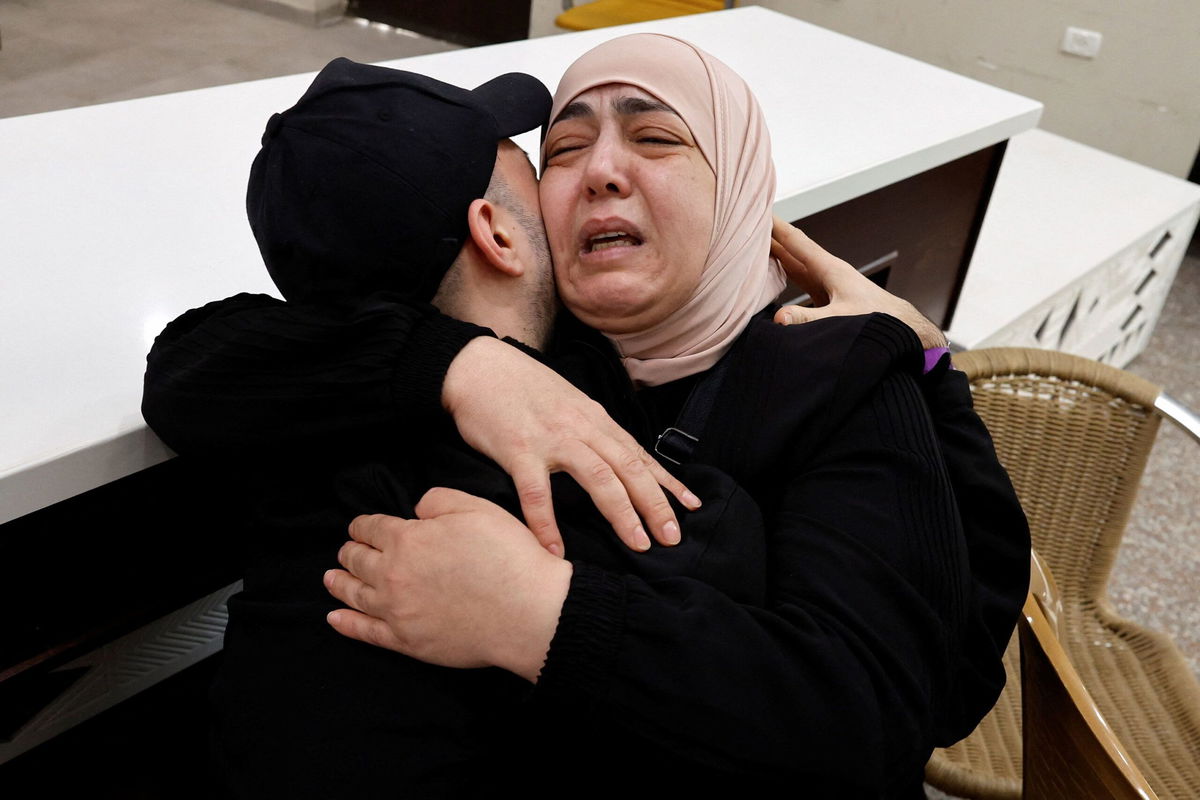 <i>Ammar Awad/Reuters via CNN Newsource</i><br/>A freed Palestinian is hugged by a relative in Ramallah