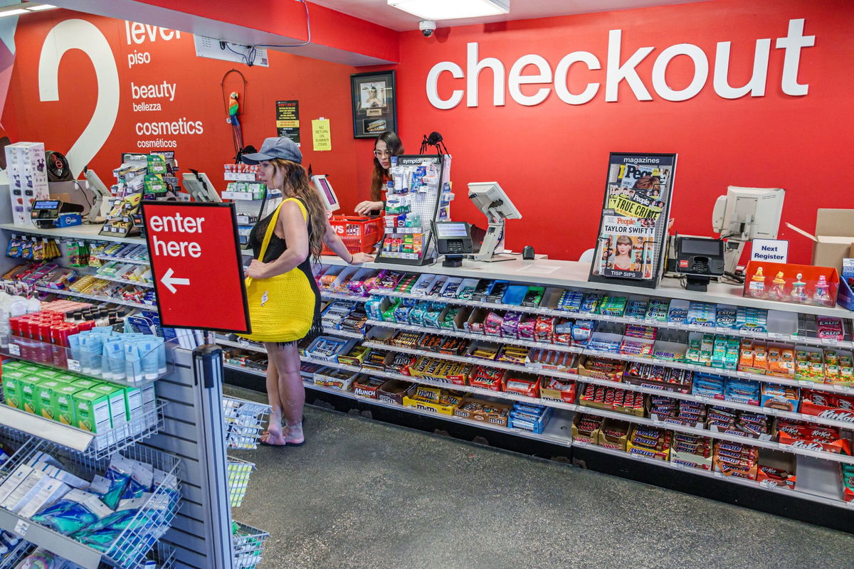 <i>Jeffrey Greenberg/Universal Images Group via Getty Images via CNN Newsource</i><br/>A person makes purchases at a CVS in Miami Beach