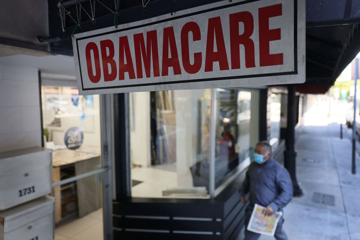 <i>Joe Raedle/Getty Images via CNN Newsource</i><br/>A pedestrian walks past the Leading Insurance Agency