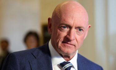 Sen. Mark Kelly speaks with members of the media before heading into a bipartisan luncheon on Capitol Hill